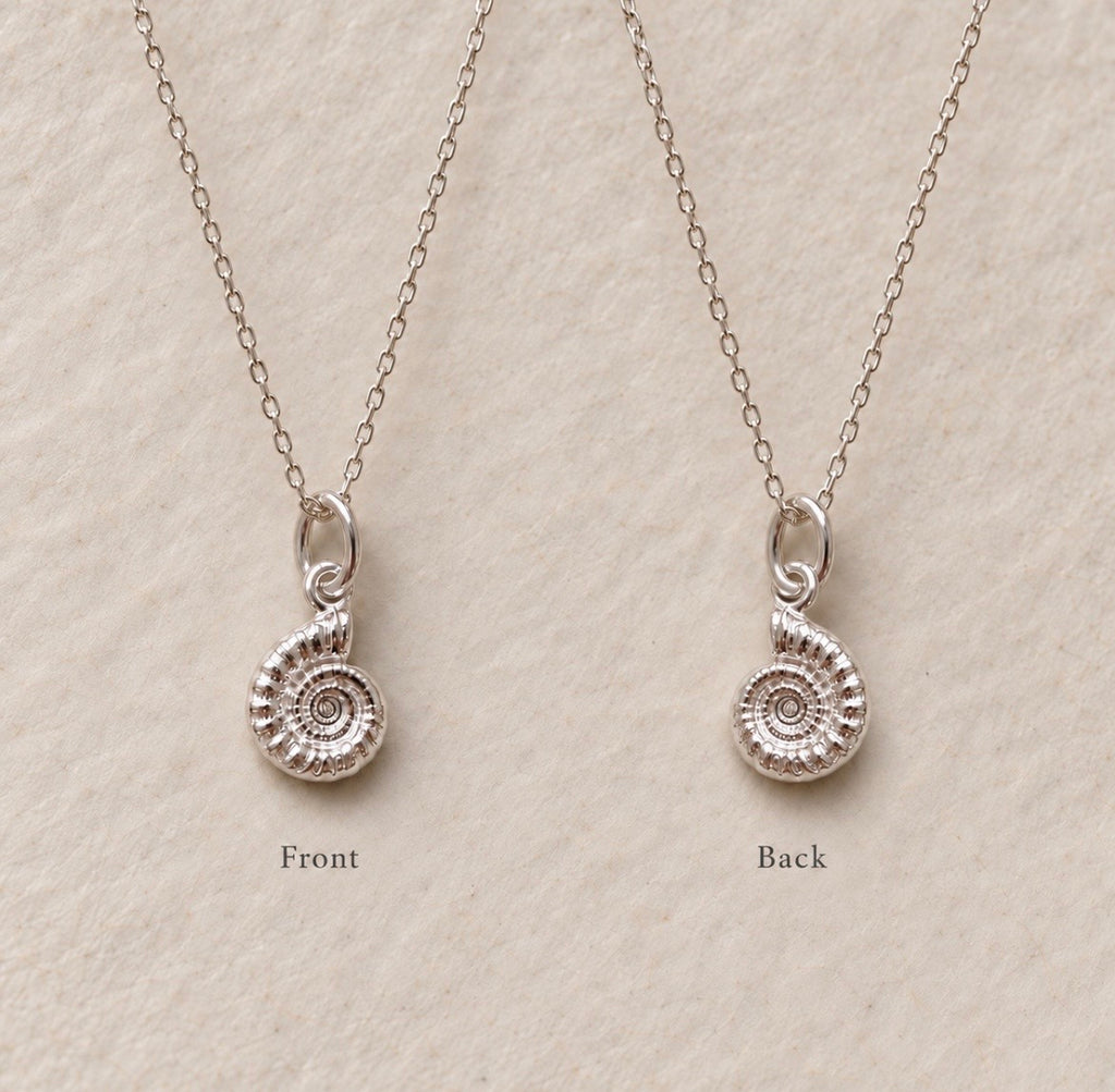 Two views of a silver ammolite spiral pendant necklace on a textured beige background, labeled 'Front' and 'Back'.